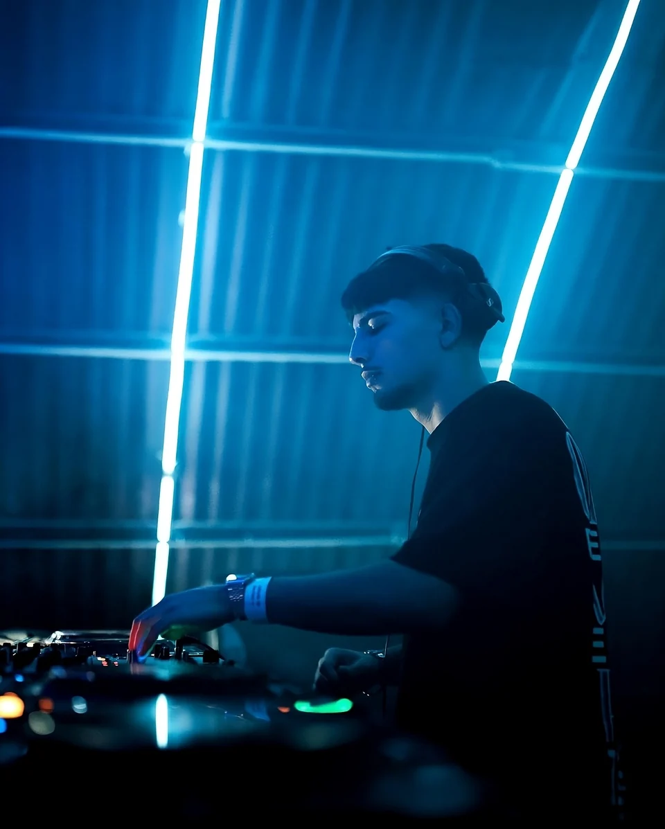 INVERTED performing beneath blue lights